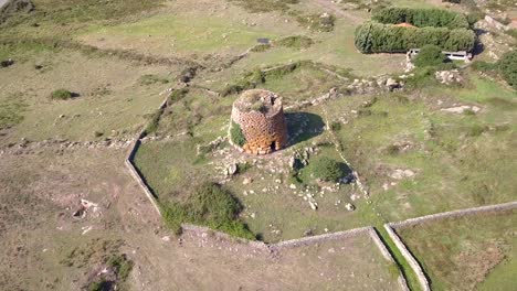 Drone-shot-hoovering-over-a-Nuraghe-in-Sardinia