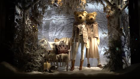 An-expensive-and-luxury-decorate-showcase-with-designer-clothes,-winter-decorations,-and-two-bears-as-the-mannequins