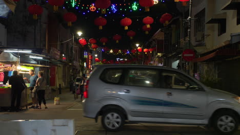 Street-Full-of-Lanterns,-Tourists-Crossing-Road,-Little-India-Street,-Night,-Malaysia