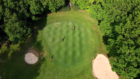 Aerial-Crane-Shot-over-Golf-Green,-with-Bunkers-and-Beautiful-Dappled-Lighting