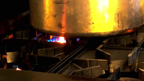 Cooking-something-in-brass-pot-and-natural-propane-gas-stove