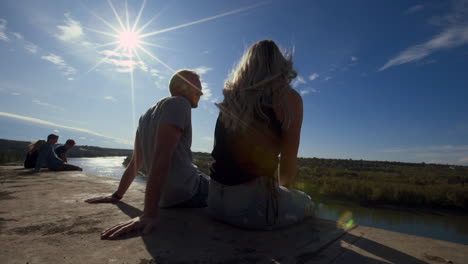 A-Slow-Motion-Dolly-Shot-of-a-Couple-Sitting-and-Talking-on-Cliffs-Edge-at-"End-of-The-World"-in-Edmonton,-Alberta