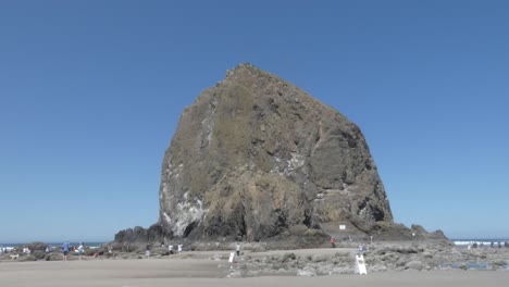 People-vacationing-at-haystack-rock-on-a-sunny-clear-day
