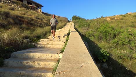 jogging-down-the-stairs-to-ghajn-tuffieha-beach