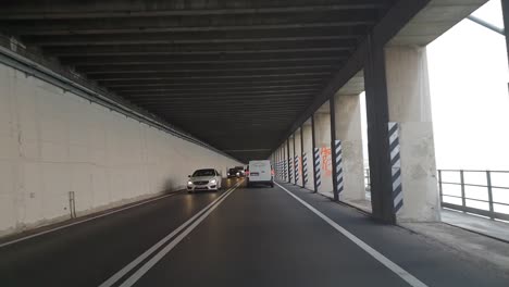 Driving-through-a-tunnel-underground,-close-to-Lake-Garda-in-Northern-Italy,-on-a-cloudy-autumn-day
