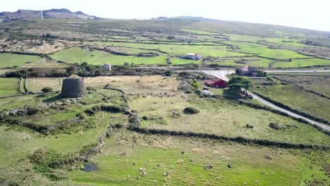 Drone-aerial-shot,-over-point-of-interest-of-nuraghe-in-Sardinia