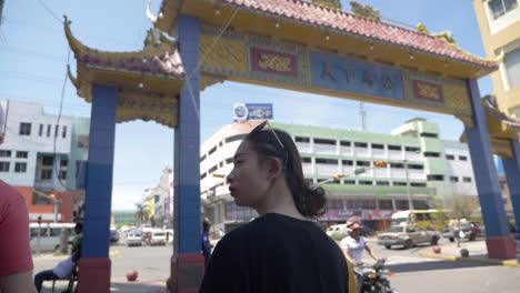 Slow-motion-of-beautiful-young-Asian-woman-walking-through-Chinatown-in-Santo-Domingo