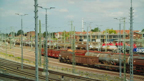 SBB-Cargo-double-heading-locos-with-tank-train-is-passing-rail-yard