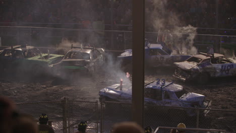 Demolition-Derby-Car-Ramming-Each-Other,-Crowd-In-Background,-Night,-Slow-Motion