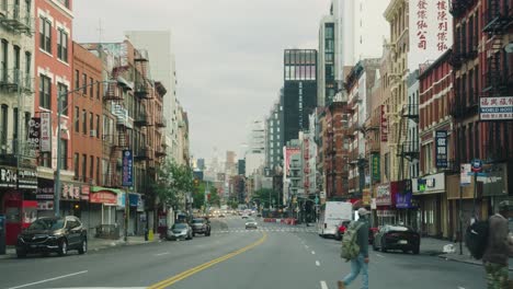 Pov-car-drive-on-road-of-New-York-City-during-cloudy-day-in-China-Town-District