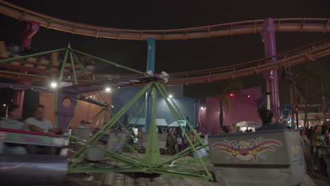 People-riding-the-rides-and-rollercoaster-at-Santa-Monica's-Pacific-Park-at-night-during-summer-in-slow-motion