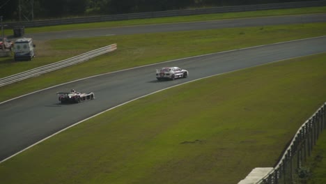 Slow-Motion-Tracking-Shot-of-Two-Race-Cars-Cornering
