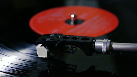 Panning-shot-of-black-vintage-vinyl-record-spinning-on-a-turntable-slow-motion