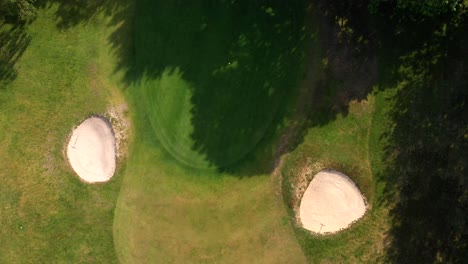 Overhead-Rotating-Aerial-Shot-of-English-Golf-Green-and-Bunkers