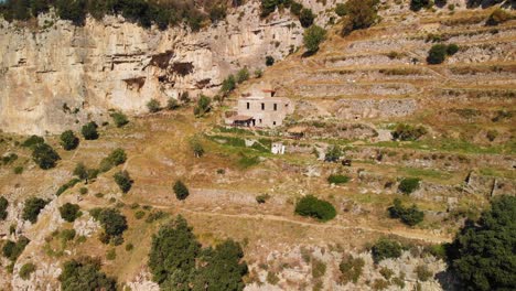 Aerial-view-of-stone-house-on-the-hill-side-near-Path-of-the-Gods-on-Amalfi-coast