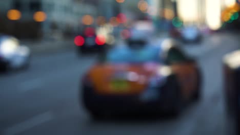 A-blurred-megapolis'-street-where-a-woman-is-taking-a-taxi-and-driving-away-during-the-winter-in-Chicago,-IL
