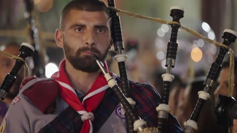 CU:-Bearded-man-plays-bagpipes-in-Easter-parade-in-Nazareth,-Israel