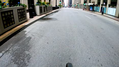 hyper-lapse-point-of-view-of-a-bike-ride-along-a-green-bike-path-in-the-city-metro-area-during-a-sunny-day