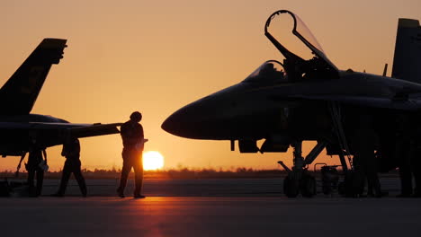 Flight-crew-prepares-Navy-Blue-Angels-for-airshow-during-early-morning-sunrise-in-slow-motion