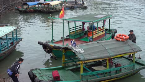 Junger-Mann-Steigt-Auf-Ein-Traditionelles-Hölzernes-Taxiboot-Auf-Der-Insel-Catba-In-Vietnam