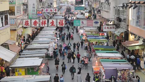 People-Walking-In-The-Middle-Of-Market-Stalls-In-Hongkong-At-Daytime---High-Angle-Shot