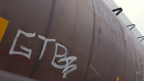 Graffiti-Tag-On-Side-Of-Parked-Freight-Train