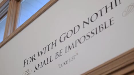 Low-Angle-View-Of-Bible-Scripture-Quote-On-Home-Wall
