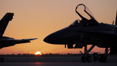 Jet-heat-exhaust-from-a-Navy-Blue-Angel-distorting-the-golden-sunrise-peeking-over-the-horizon-at-Boca-Chica-tarmac-near-Key-West-FL