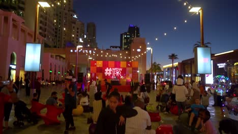 Menschen-Versammelten-Sich-Während-Einer-Veranstaltung-In-Der-Abenddämmerung-Vor-Der-Bühne-Vor-Dem-Jumeirah-Beach-Residence-Gebäude-In-Dubai,-Vereinigte-Arabische-Emirate-–-Kippaufnahme