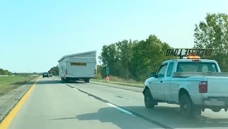 transporting-an-oversized-wide-load-prefabricated-home-on-I-96-freeway-near-Lansing,-Michigan