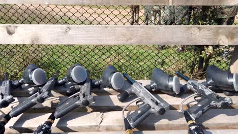 Prepared-for-outdoor-play,-black-paintball-weapons