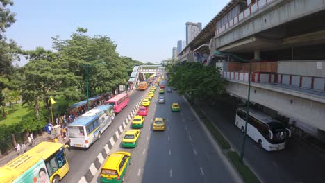 Top-view-of-a-street-with-buses,-taxis-and-cars-on-a-sunny-day