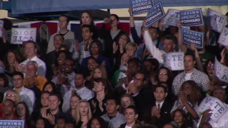 Pan-left-to-right-of-cheering-Democrat-supporters-as-they-lift-banners-and-clap-during-speeches-at-the-Moving-America-Forward-rally-at-Orr-Middle-School-in-Las-Vegas
