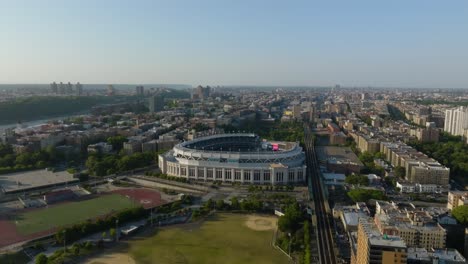 Aerial-view-tilting-toward-the-Yankee-stadium-in-Bronx,-golden-hour-in-New-York,-USA
