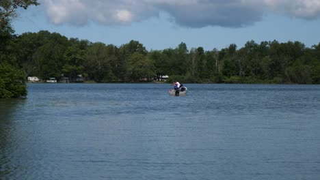 View-Of-Father-Teaching-Son-To-Fish-From-Boat-On-Lake
