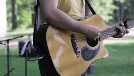View-Of-Man-Playing-Guitar-Outside.-Slow-Motion