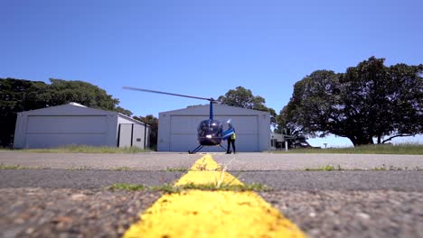 Low-angle-of-blue-helicopter-preparring-to-start-at-Sydney-airport
