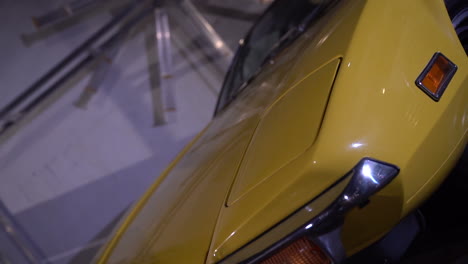 Front-bumper-of-yellow-old-Lamborghini-with-flashing-strobe-light,-rotating-shot