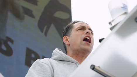 Tom-Van-Grieken,-leader-of-the-Flemish-far-right-political-party-Vlaams-Belang,-speeching-during-protest-meeting-in-Brussels,-Belgium---Close-up