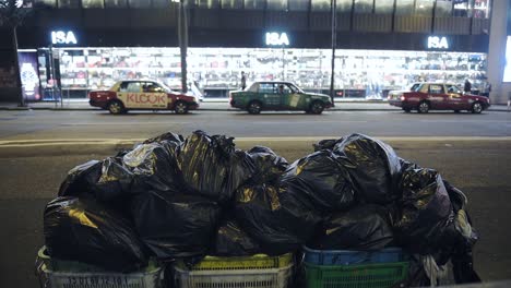 Garbage-cleanly-bagged-and-dumped-by-the-roadside-for-pickup-in-Hong-Kong---wide-shot