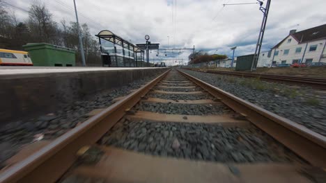 FPV-Drone-Flying-Low-Close-To-Railway-Tracks-In-Varnamo,-Sweden