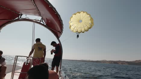 Stuntman-on-parasailing-parachute-doing-hanging-bat-trick