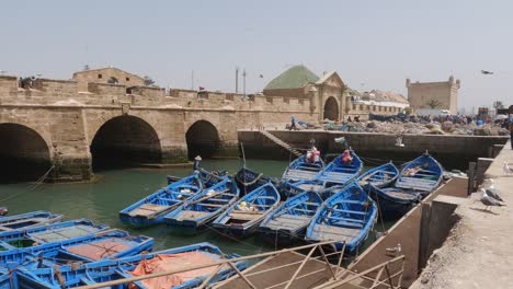 Colorful-fishing-boats-docked-near-sqala.-Essaouira,-Marrakesh