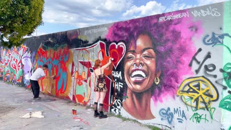 Street-Art-Artist-Spraying-New-Graffiti-on-Wall-in-Berlin-Mauerpark
