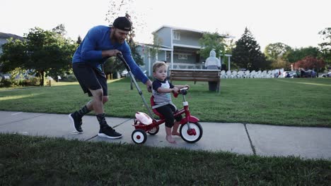 Dad-Pushing-Son-Radio-Flyer-Tricycle-Neighborhood