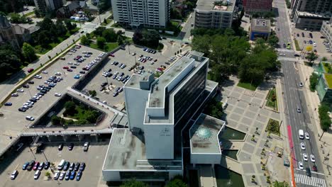 Rainbow-crosswalk-Hamilton-city-hall-aerial-drone-360-degree-panoramic-view-overlooking-front-entrance-to-the-back-parking-lot-on-a-sunny-summer-day-with-stunning-lush-green-parks-one-way-street-view