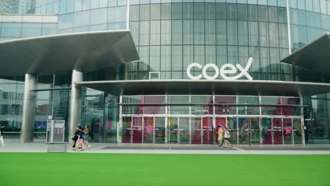 People-Passing-By-The-East-Gate-Of-COEX-Convention-And-Exhibition-Center-In-Gangnam-District,-Seoul,-South-Korea