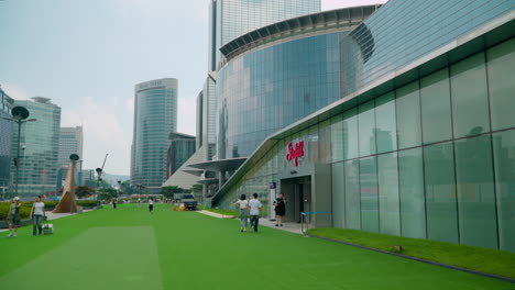 Gente-Caminando-En-El-Césped-Frente-Al-Centro-Comercial-Starfield-Coex-En-Gangnam,-Seúl,-Corea-Del-Sur