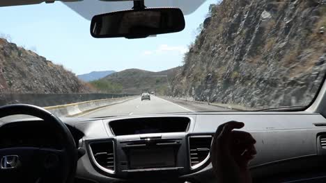 Pilot-and-co-pilot-talking-inside-the-car-driving-on-the-freeway-in-Mexico