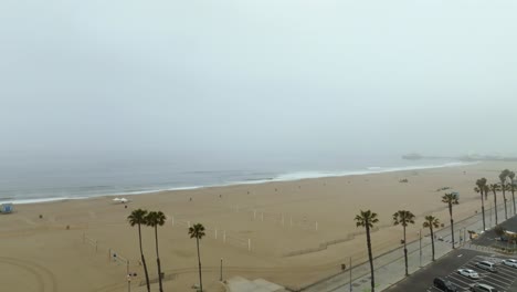 Ascending-aerial-view-of-the-Venice-Beach,-foggy-day-in-Los-Angeles,-USA